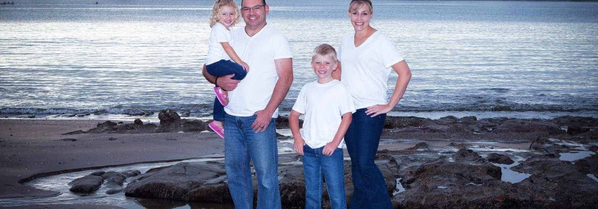 Family portrait at Castor Bay beach with Rangitoto Island