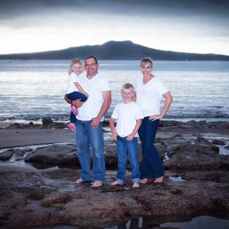 Family portrait at Castor Bay beach with Rangitoto Island