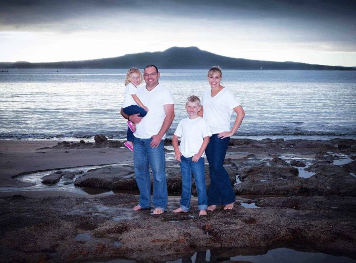 Family portrait at Castor Bay beach with Rangitoto Island